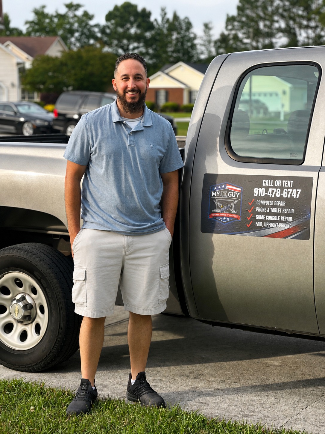Justin Pinto, owner of My I.T. Guy, standing by his work truck in Jacksonville NC